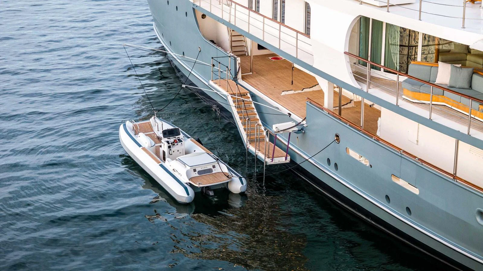 A tender is docked alongside the yacht, showcasing easy access and convenience. aboard JUST B Yacht for Sale