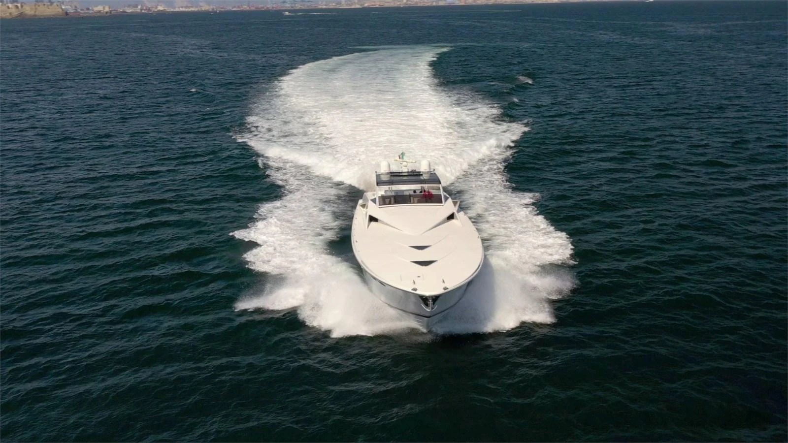 A sleek yacht cruises swiftly across the open water, leaving a trail of white wake behind. aboard WHITE & SILVER Yacht for Sale