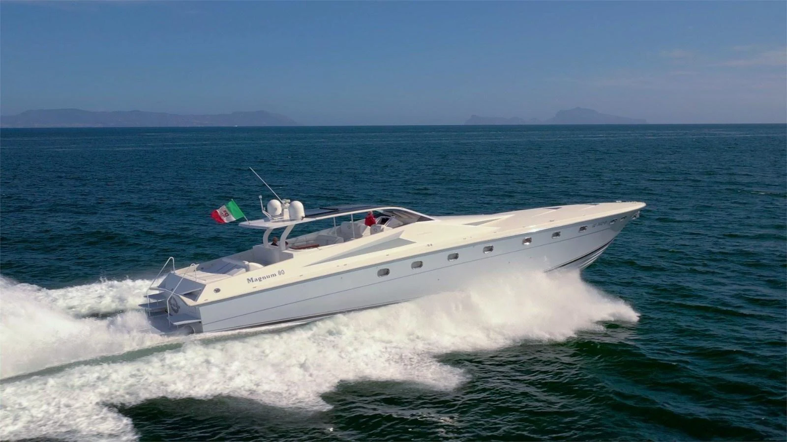 A sleek yacht cruises swiftly through the open sea, showcasing its elegant design and powerful performance. aboard WHITE & SILVER Yacht for Sale