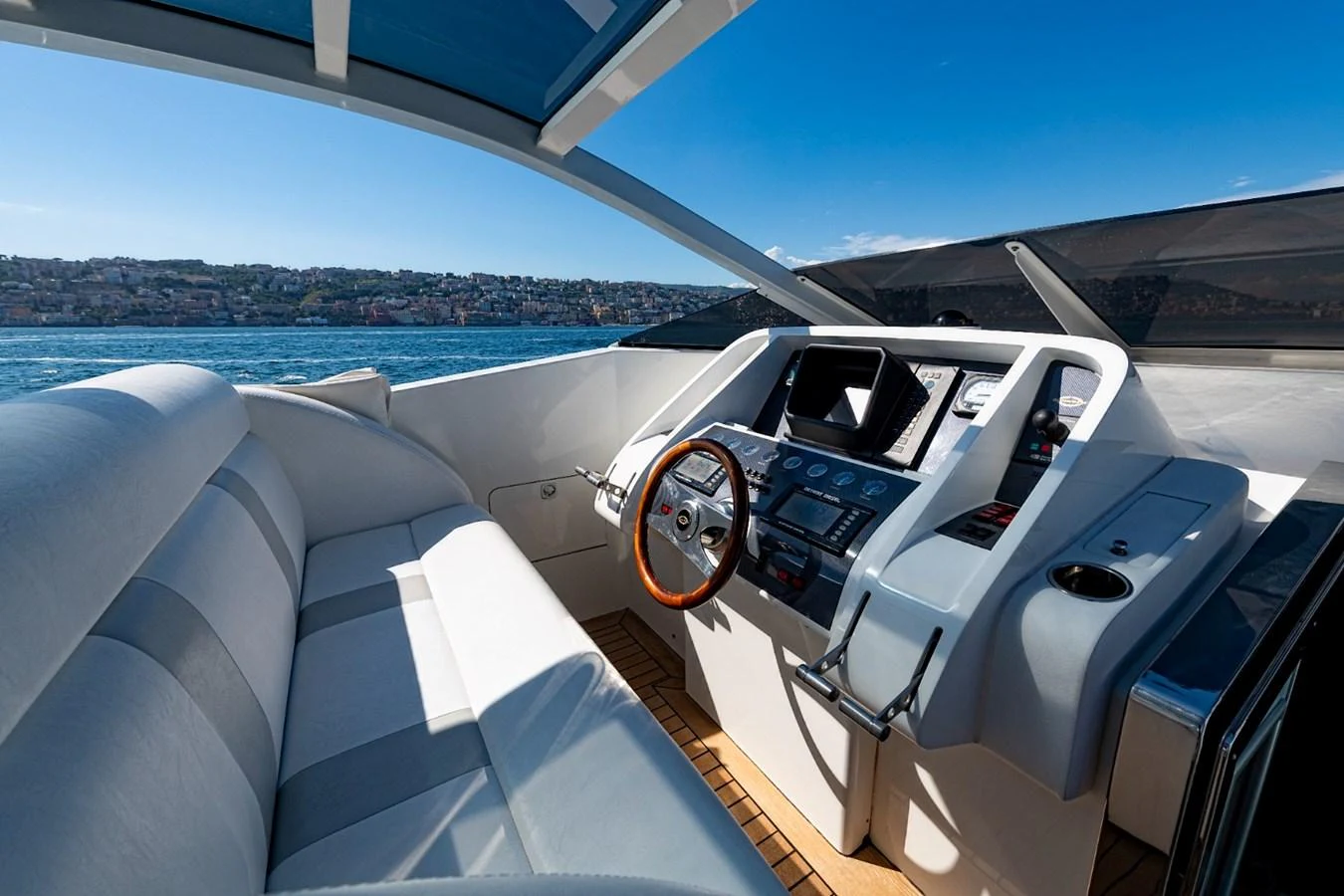 The helm station features a sleek design with modern navigation equipment and a comfortable seating area. aboard WHITE & SILVER Yacht for Sale
