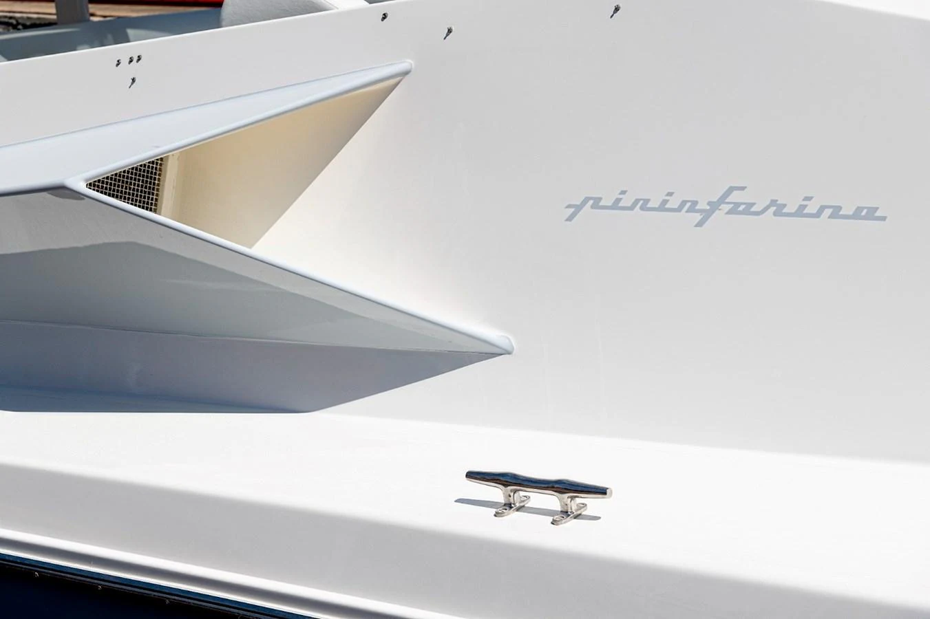 A close-up of a sleek yacht detail showcasing a stylish design element and a cleat. aboard WHITE & SILVER Yacht for Sale