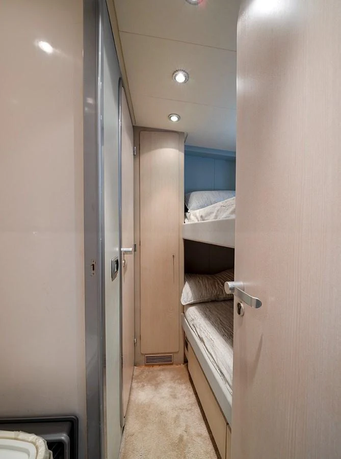 This cozy bunk cabin offers a comfortable sleeping arrangement with modern finishes. aboard WHITE & SILVER Yacht for Sale