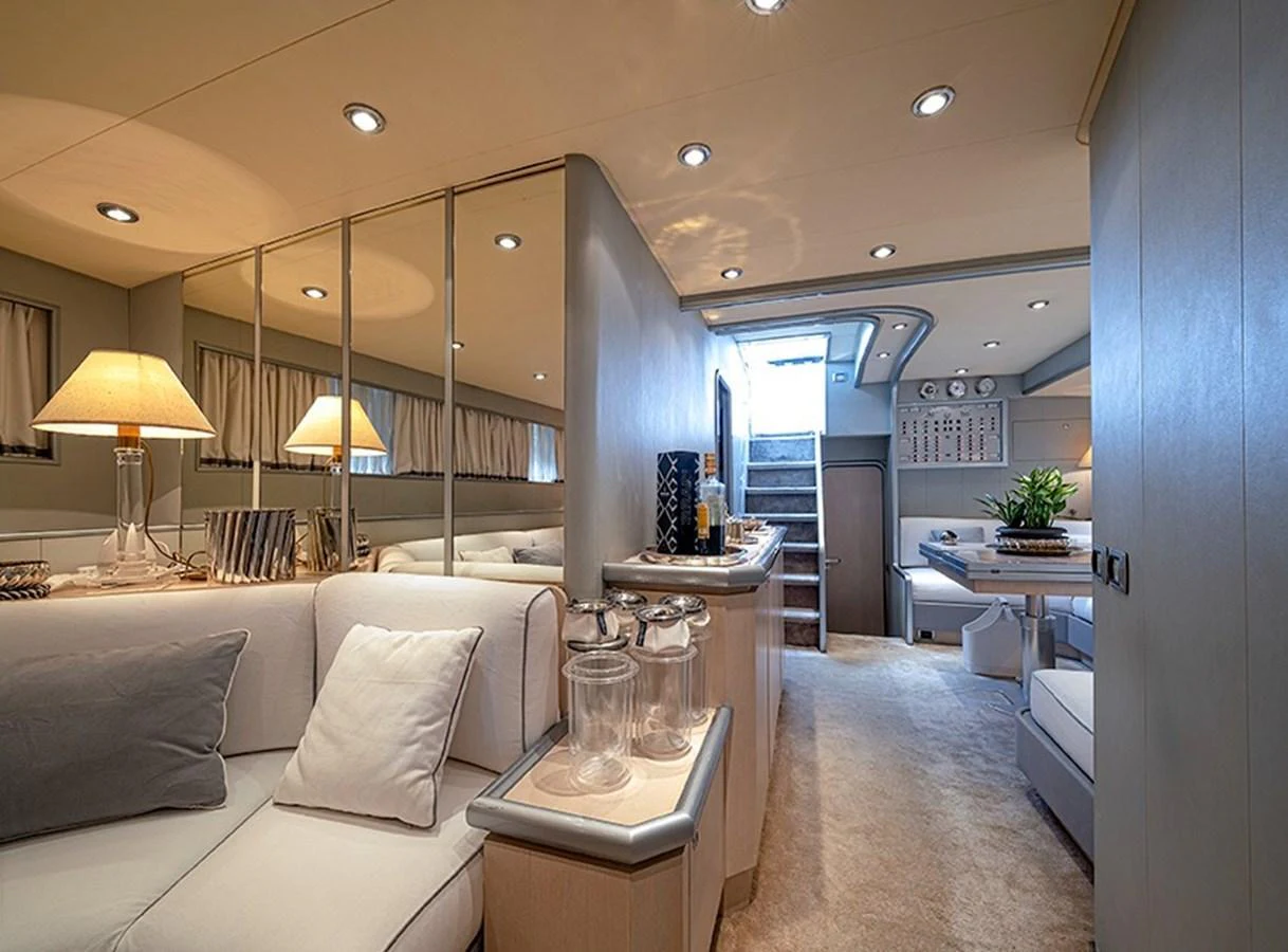 The yacht's interior features a cozy and well-lit living area with comfortable seating and elegant decor. aboard WHITE & SILVER Yacht for Sale