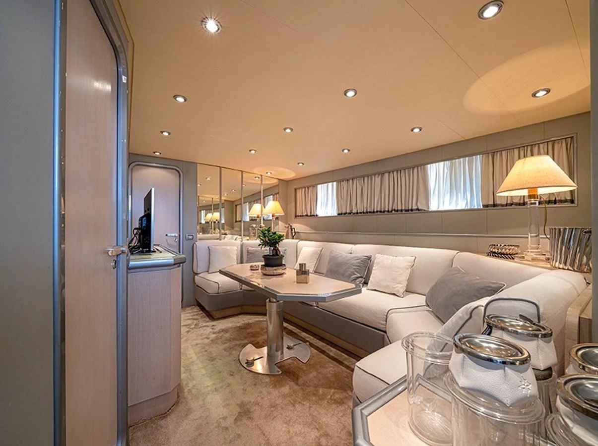 The salon features a cozy seating area with elegant lighting and modern decor. aboard WHITE & SILVER Yacht for Sale