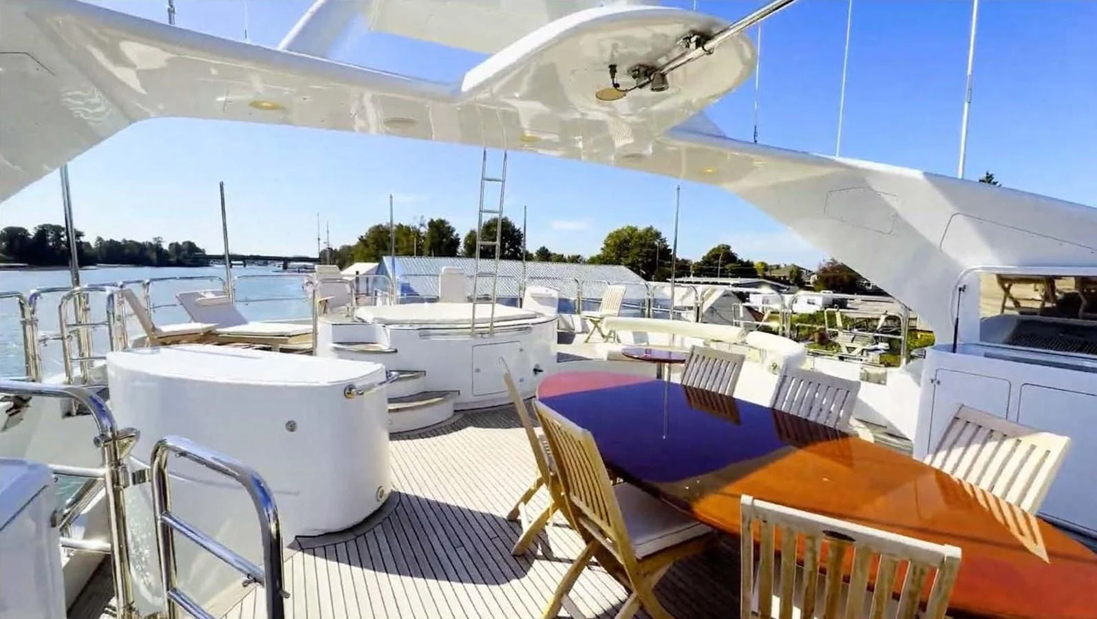 The flybridge offers a spacious and luxurious outdoor dining and lounging area with stunning views. aboard DOMANI Yacht for Sale