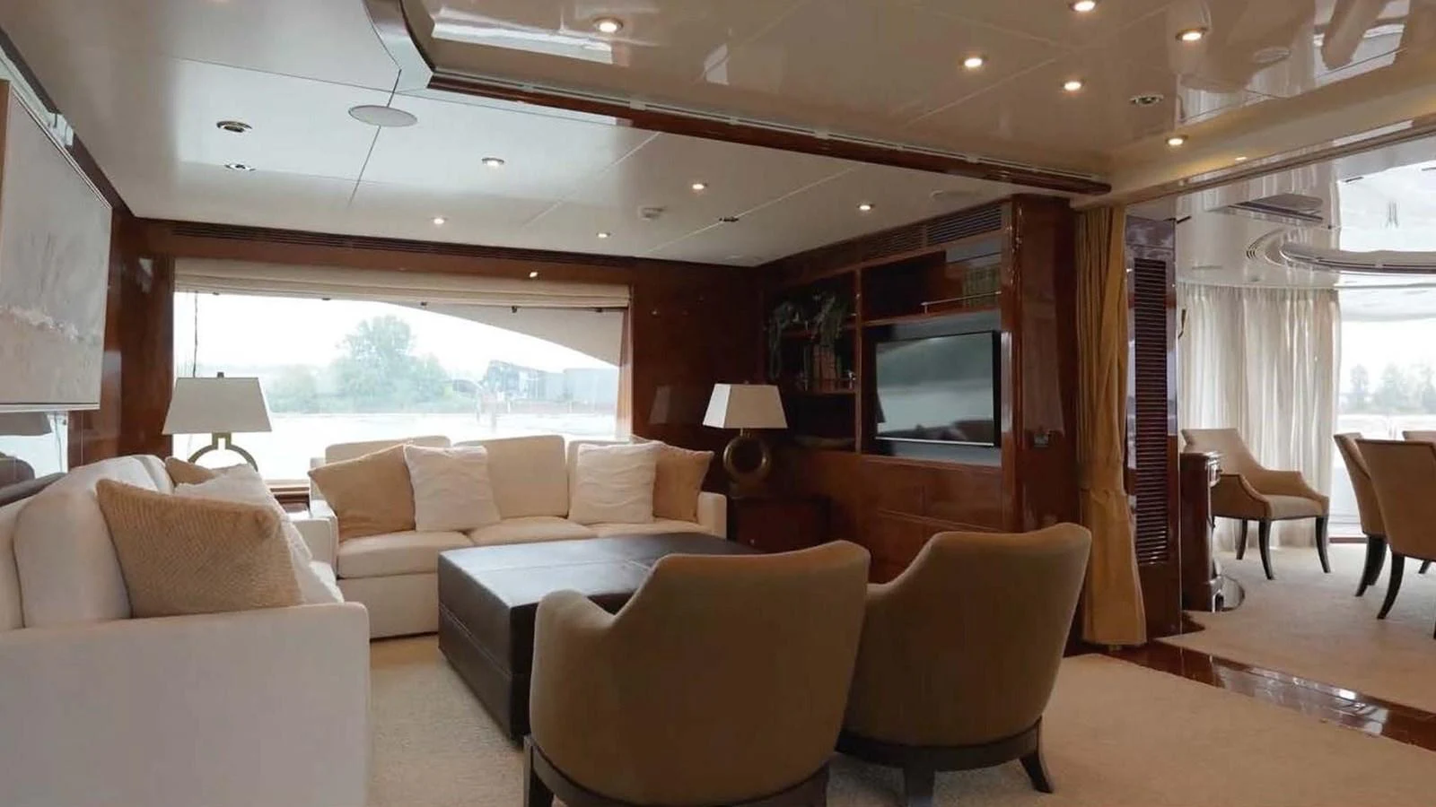 The yacht's salon features a spacious seating area with plush sofas and elegant decor. aboard DOMANI Yacht for Sale