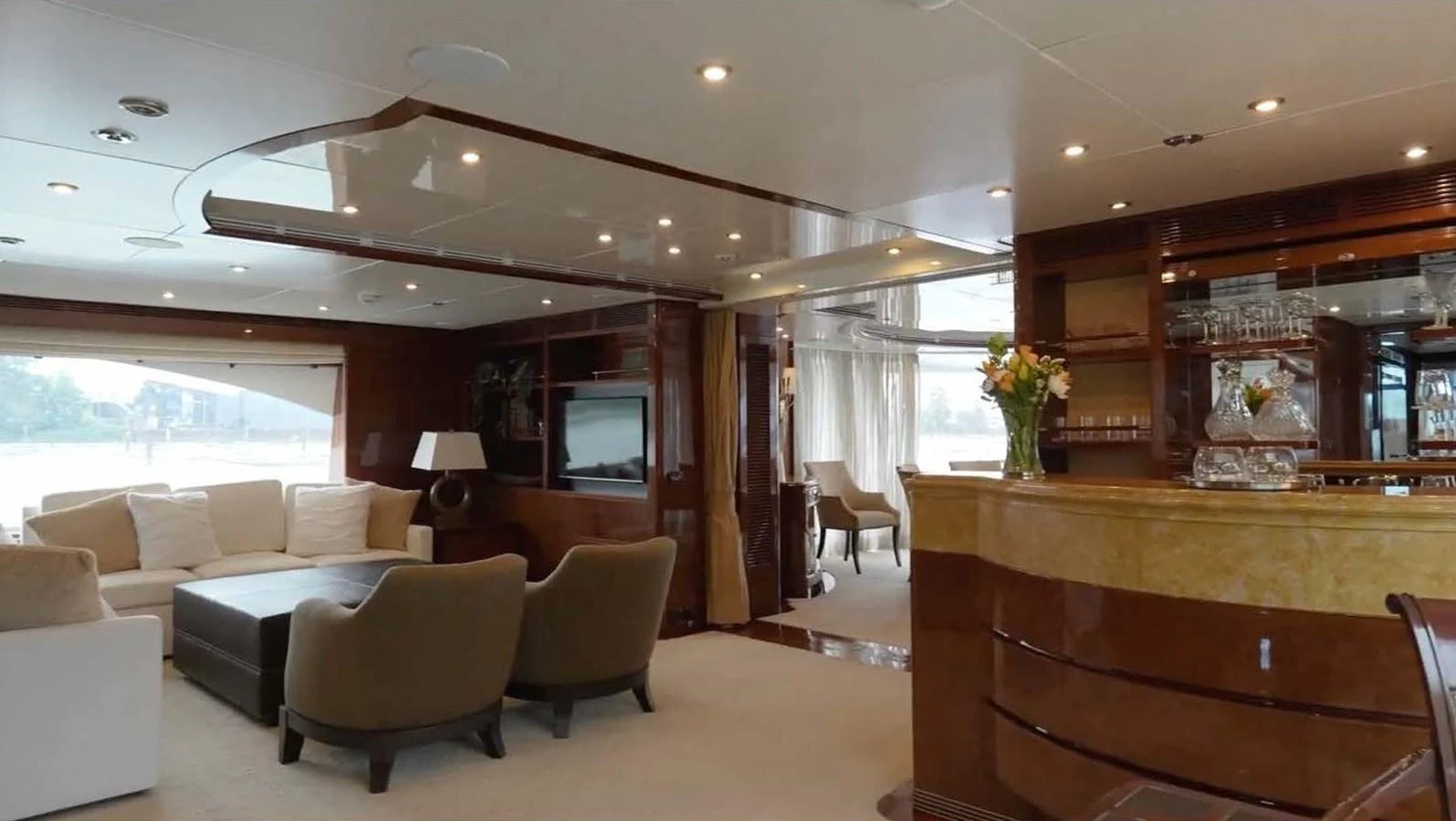 The salon features plush seating, a stylish bar, and elegant decor, creating a luxurious and inviting atmosphere. aboard DOMANI Yacht for Sale