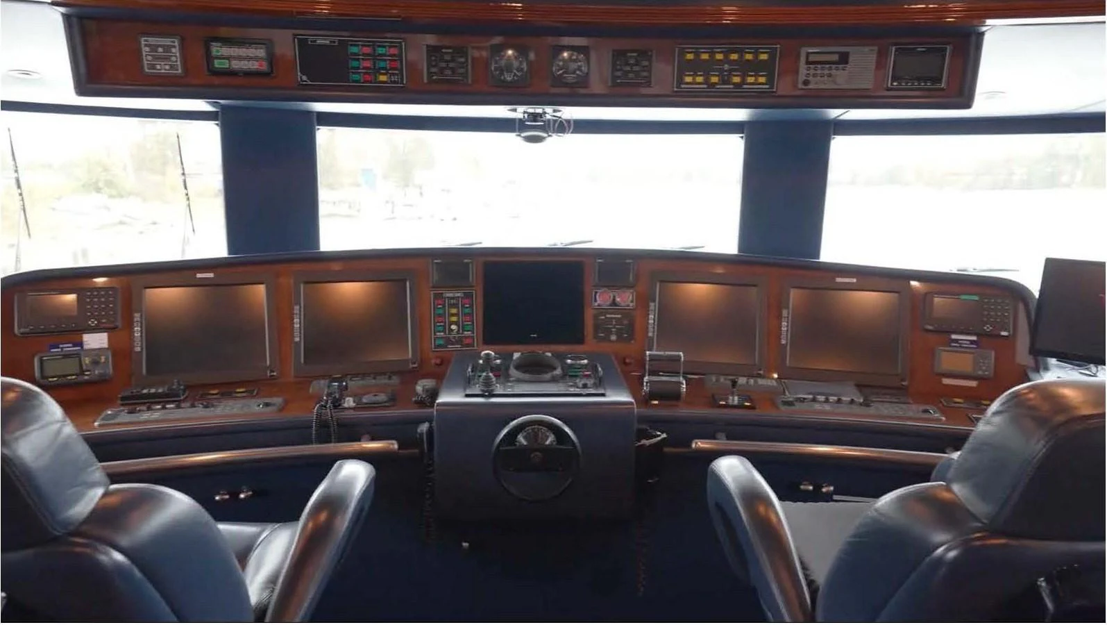 The helm station features advanced navigation equipment and luxurious seating. aboard DOMANI Yacht for Sale