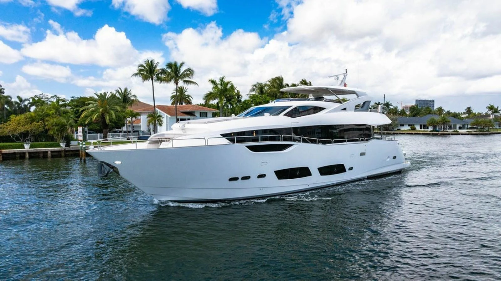 A sleek and modern yacht glides gracefully through calm waters under a bright blue sky. aboard STAR OF THE SEA Yacht for Sale