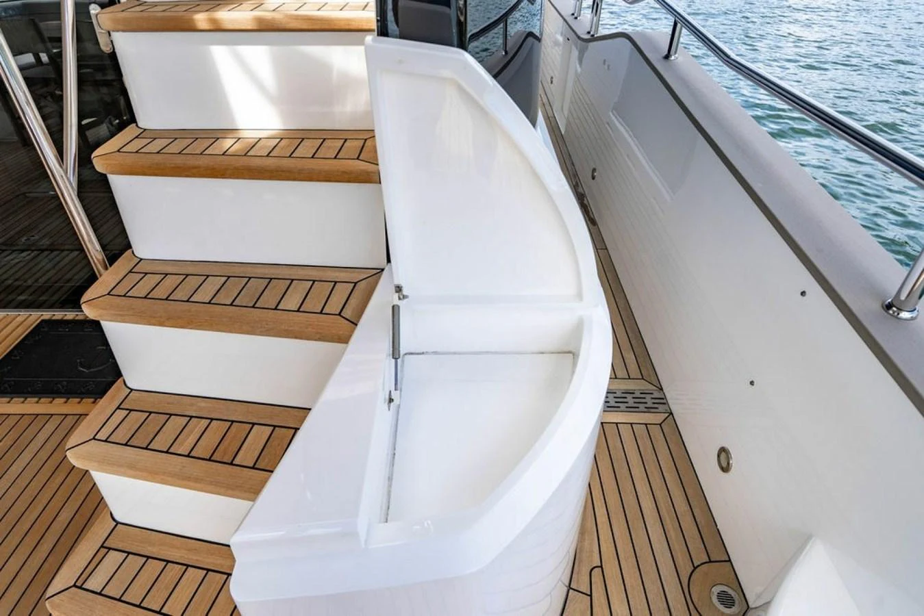 A sleek deck storage compartment is integrated into the yacht's staircase, showcasing practical design. aboard STAR OF THE SEA Yacht for Sale