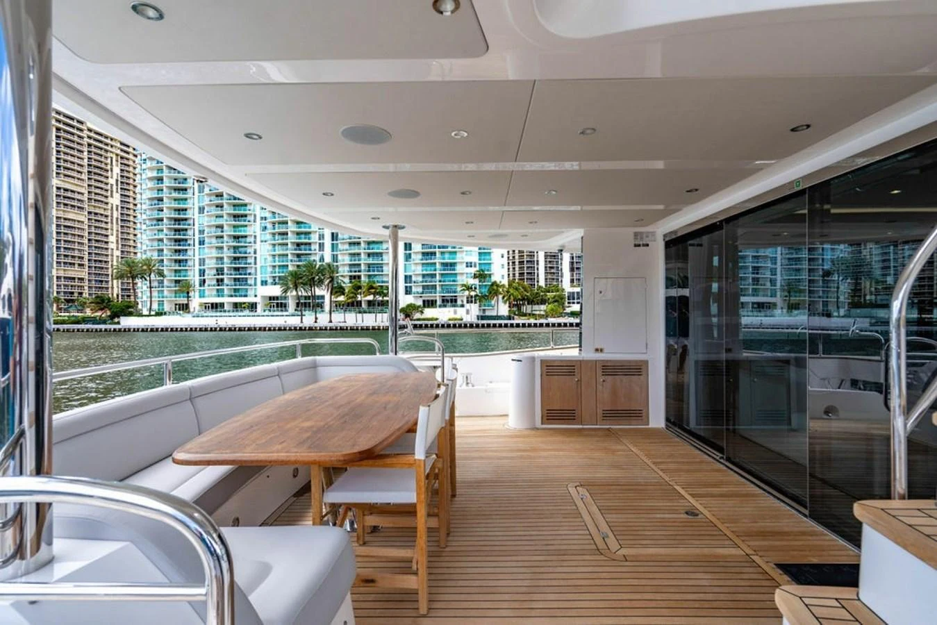 The aft deck features a spacious seating area with a wooden dining table, perfect for alfresco dining. aboard STAR OF THE SEA Yacht for Sale