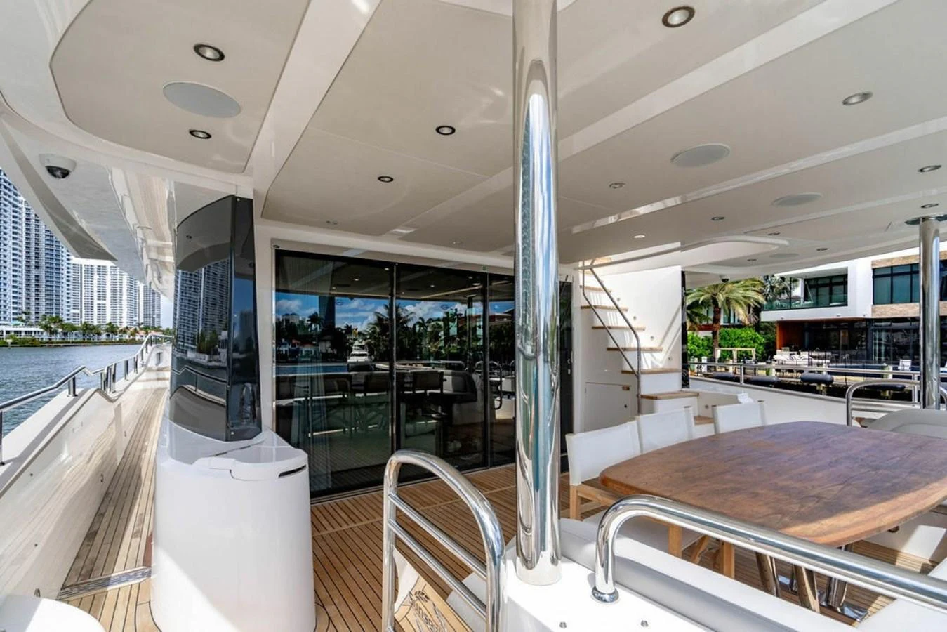 The aft deck features a spacious dining area with a wooden table and modern seating, perfect for alfresco dining. aboard STAR OF THE SEA Yacht for Sale
