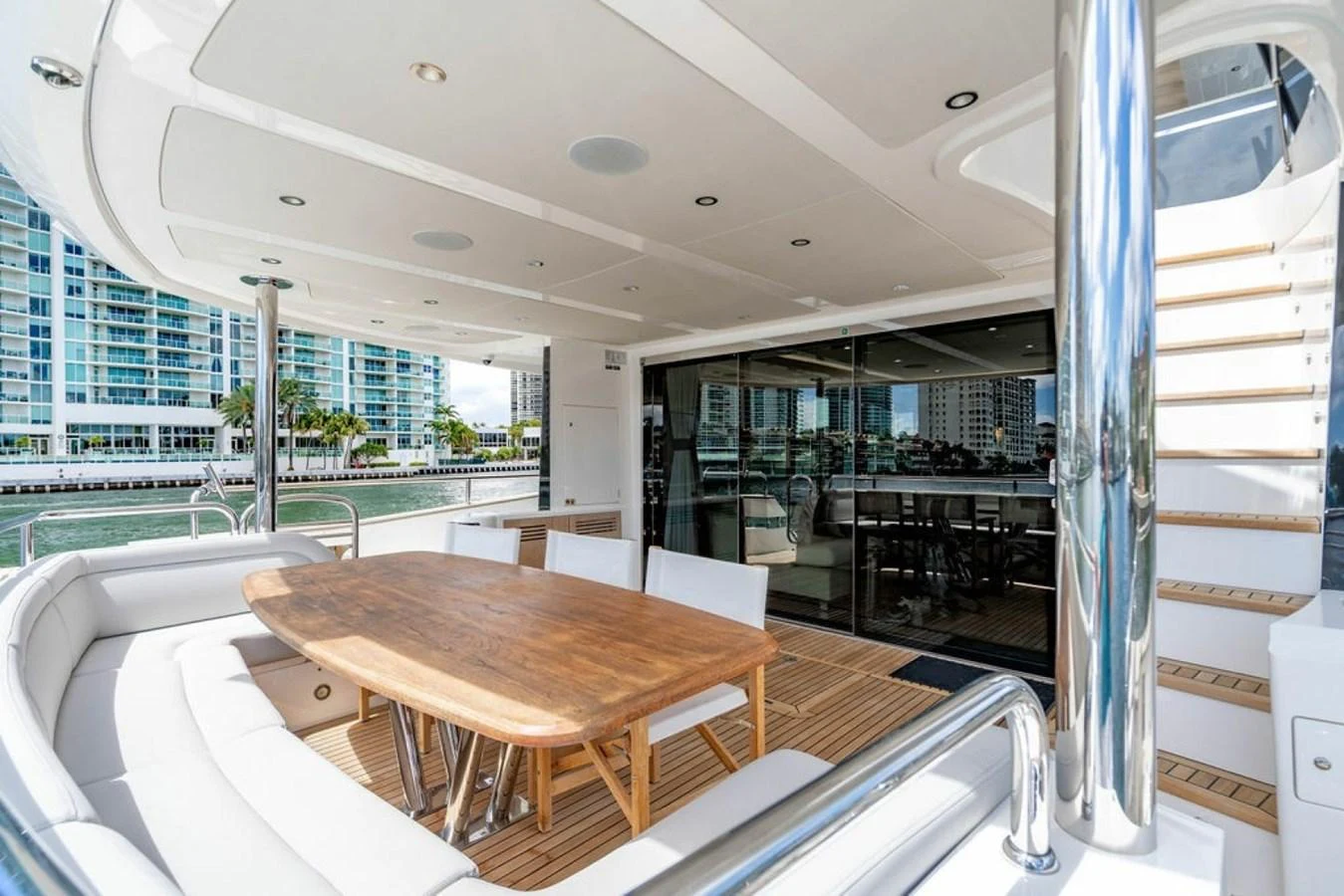 The aft deck features a spacious dining area with a wooden table and comfortable seating, perfect for alfresco meals. aboard STAR OF THE SEA Yacht for Sale