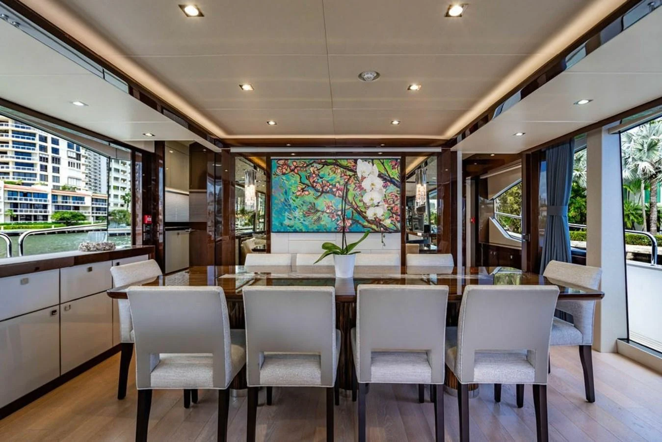 The yacht's dining area features a large table with seating for eight, complemented by elegant decor and a scenic view. aboard STAR OF THE SEA Yacht for Sale