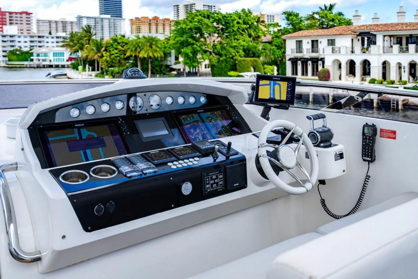 The helm station features advanced navigation equipment and a comfortable steering area with a scenic waterfront backdrop. aboard STAR OF THE SEA Yacht for Sale