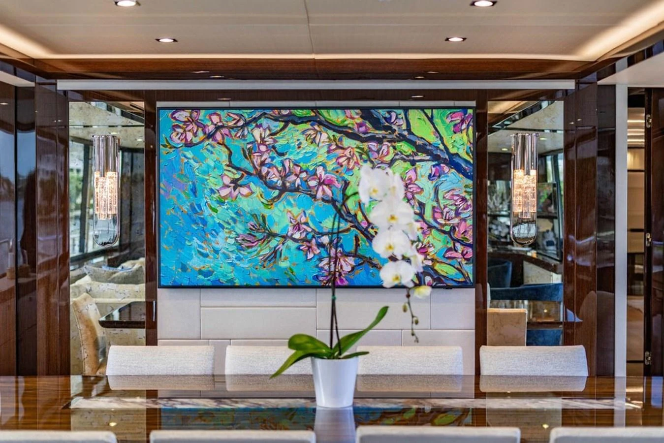 The yacht's interior features a vibrant and artistic decor with a large, colorful painting and elegant furnishings. aboard STAR OF THE SEA Yacht for Sale