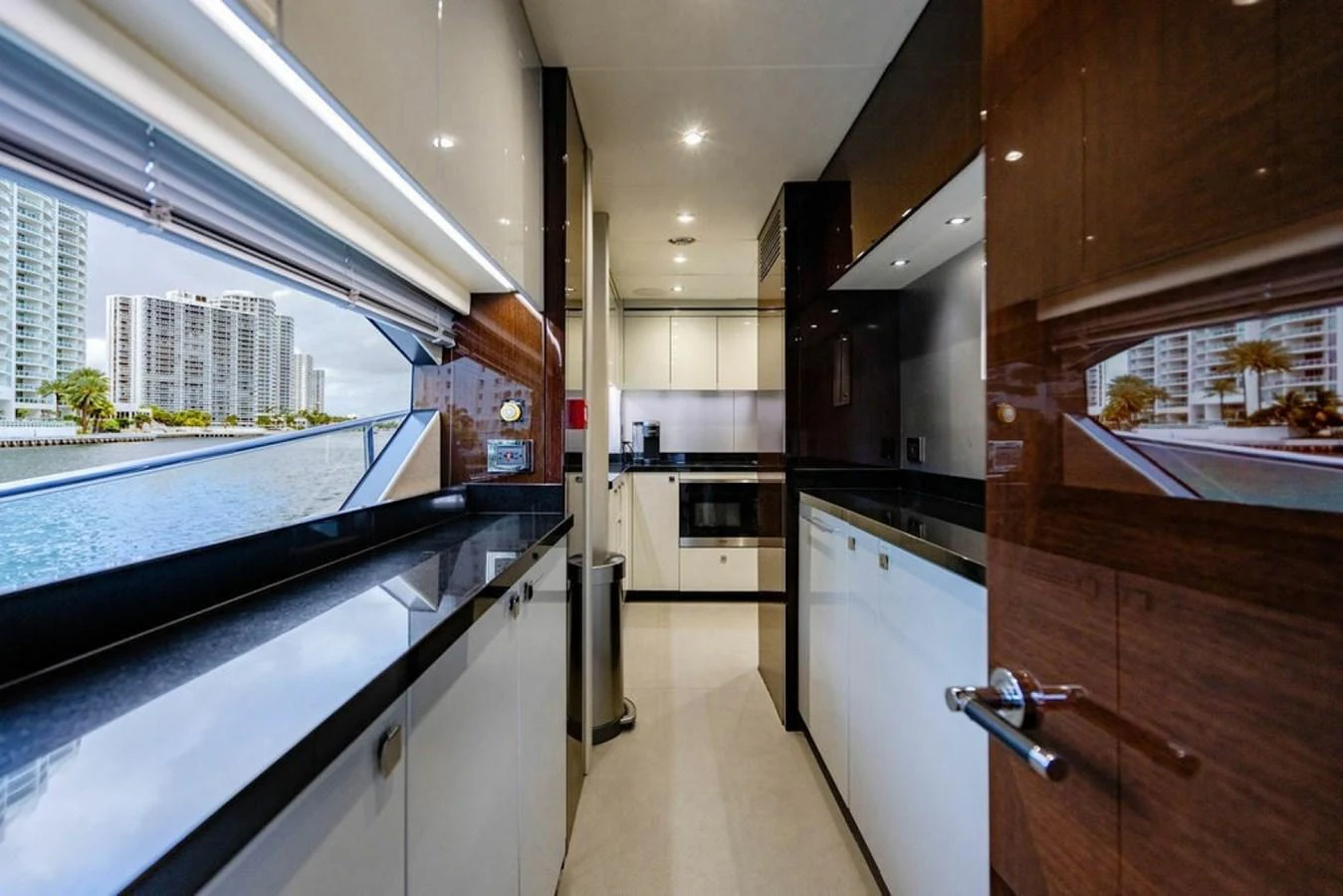 The modern galley features sleek cabinetry and a stunning view through large windows. aboard STAR OF THE SEA Yacht for Sale