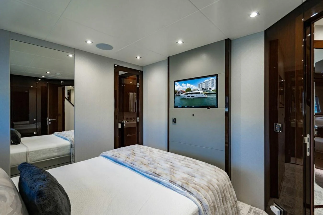 The stateroom features a cozy bed, modern decor, and a flat-screen TV. aboard STAR OF THE SEA Yacht for Sale