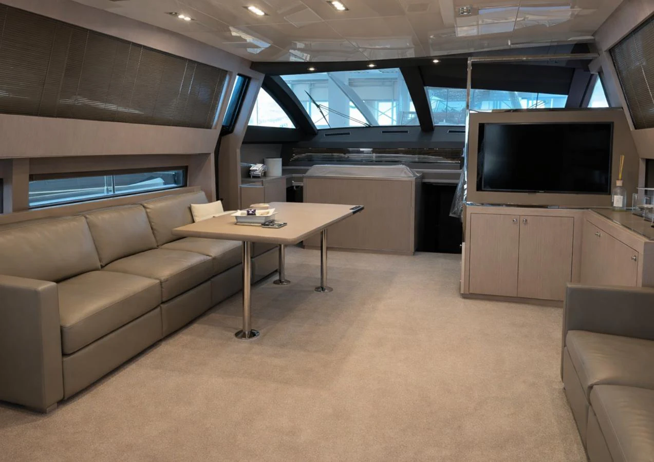 The salon features a spacious seating area with a large sofa and a flat-screen TV, creating a comfortable and inviting atmosphere. aboard SPEEDY BEAR Yacht for Sale