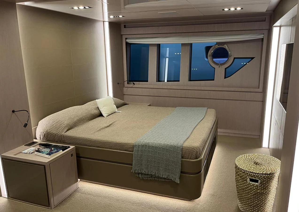 A luxurious stateroom featuring a comfortable bed and modern decor. aboard SPEEDY BEAR Yacht for Sale