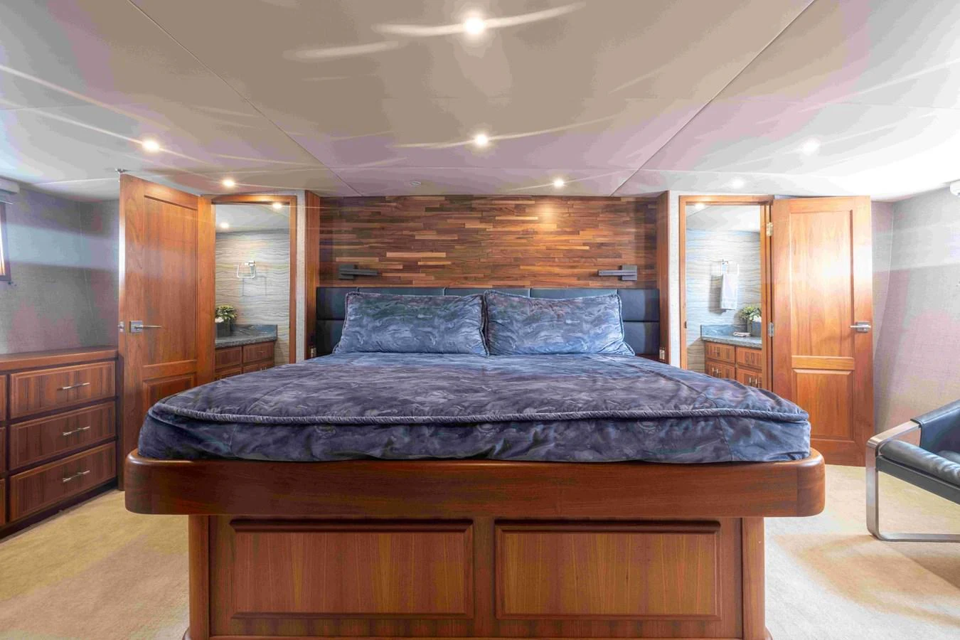 The master stateroom features a luxurious bed with elegant wood finishes and ample lighting. aboard SAPPHIRE SEA II Yacht for Sale