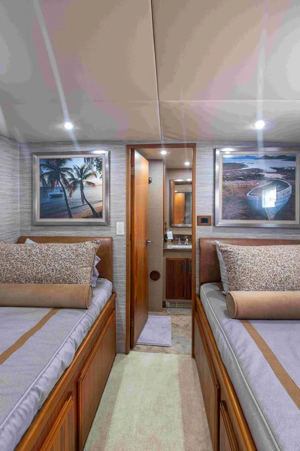 The guest stateroom features twin beds with elegant bedding and tasteful decor. aboard SAPPHIRE SEA II Yacht for Sale