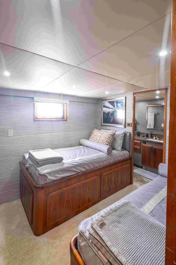 A cozy guest cabin with twin beds and an ensuite bathroom. aboard SAPPHIRE SEA II Yacht for Sale