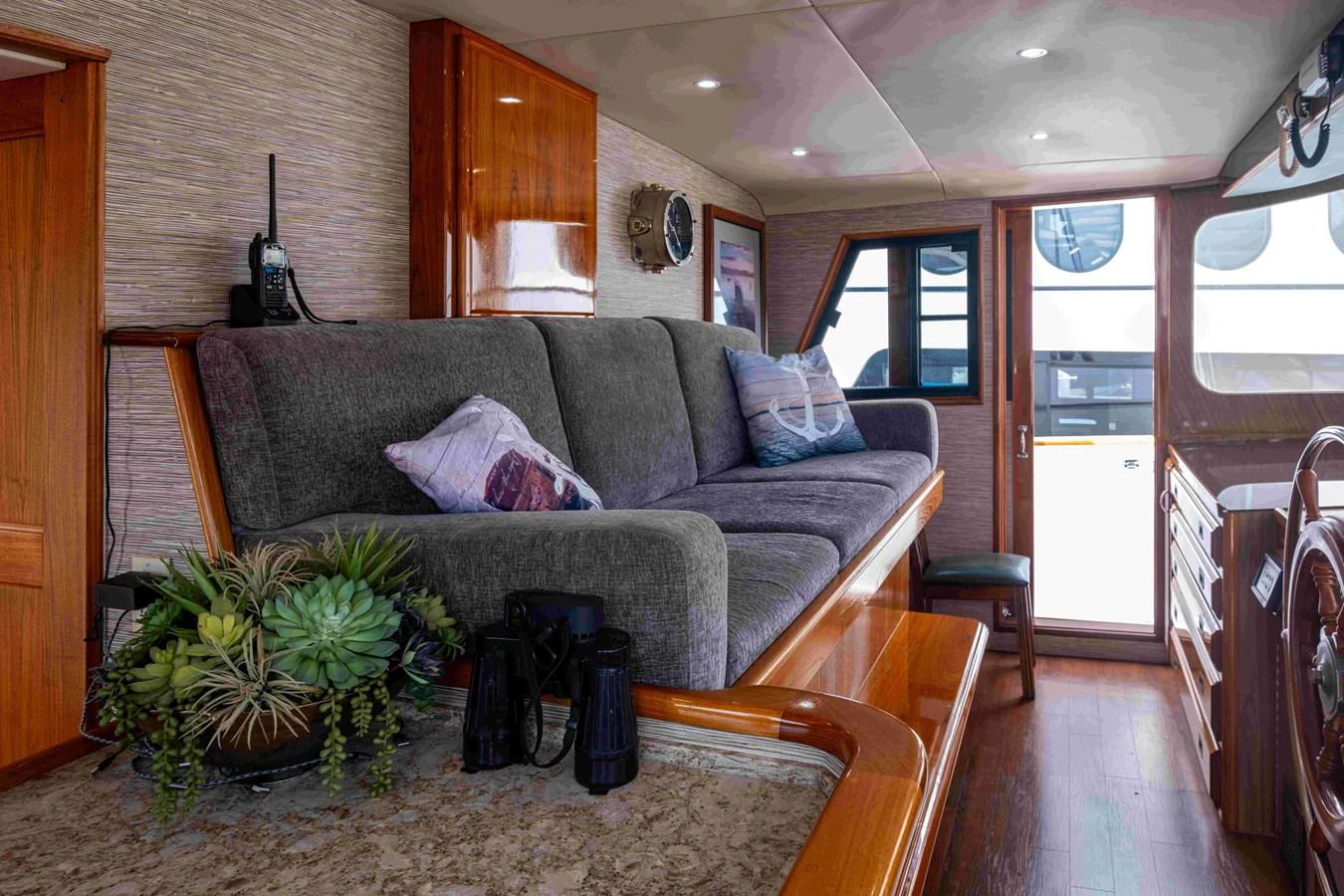 The yacht's interior features a cozy seating area with plush cushions and a view of the exterior through large windows. aboard SAPPHIRE SEA II Yacht for Sale