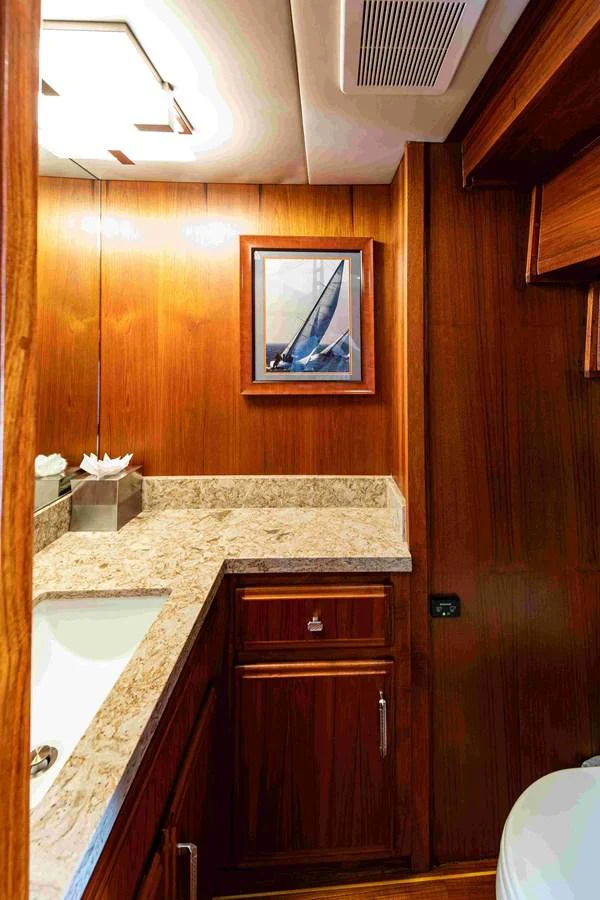 The yacht's bathroom features elegant wood paneling and a marble countertop. aboard SAPPHIRE SEA II Yacht for Sale