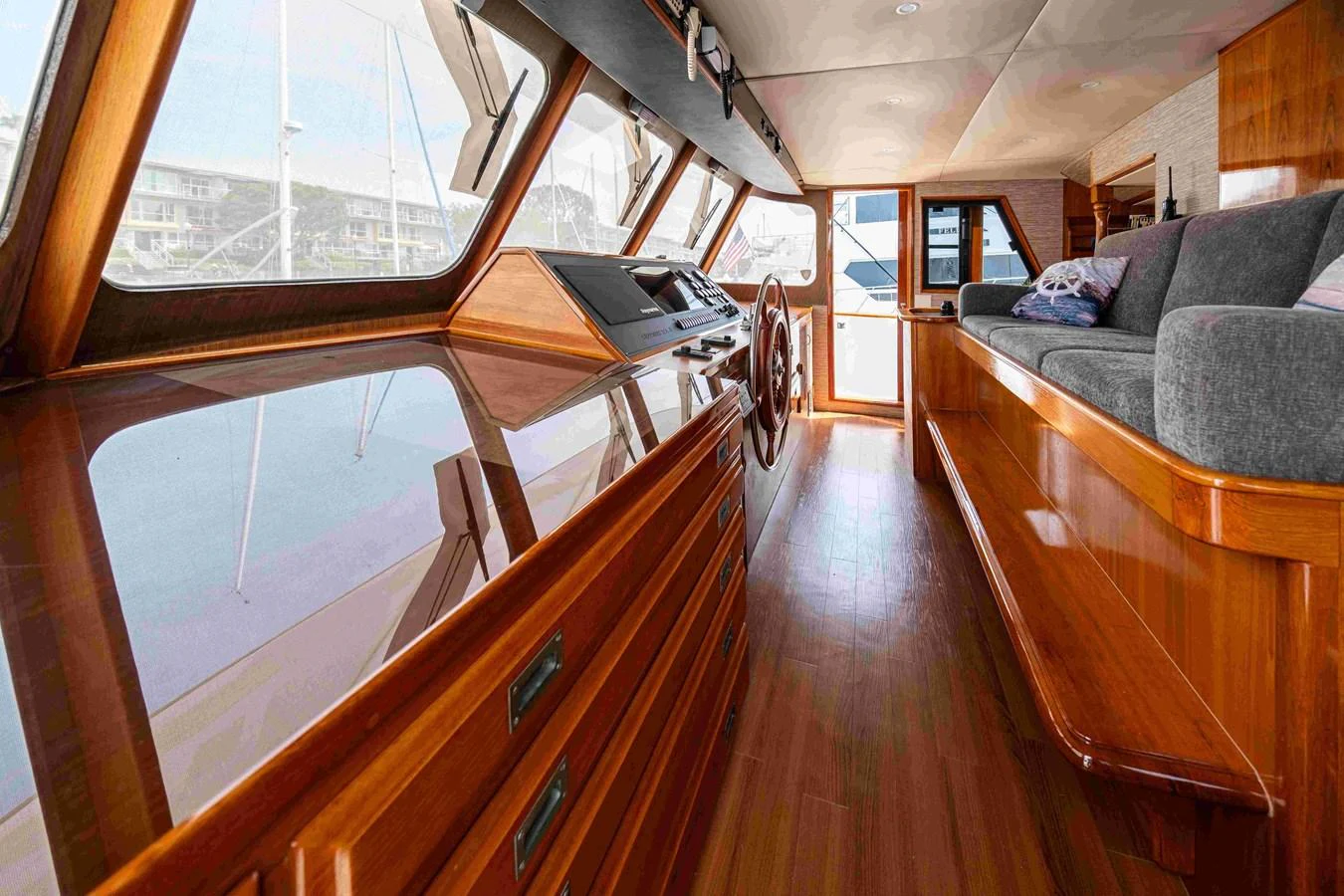The helm area features polished wood finishes and expansive windows for a panoramic view. aboard SAPPHIRE SEA II Yacht for Sale