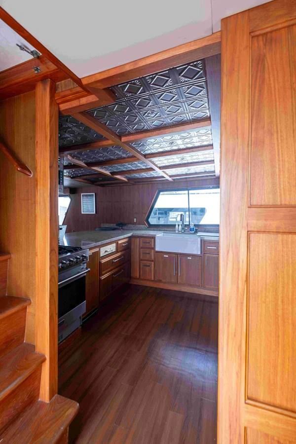 The galley features rich wooden cabinetry and modern appliances, creating a warm and functional space. aboard SAPPHIRE SEA II Yacht for Sale