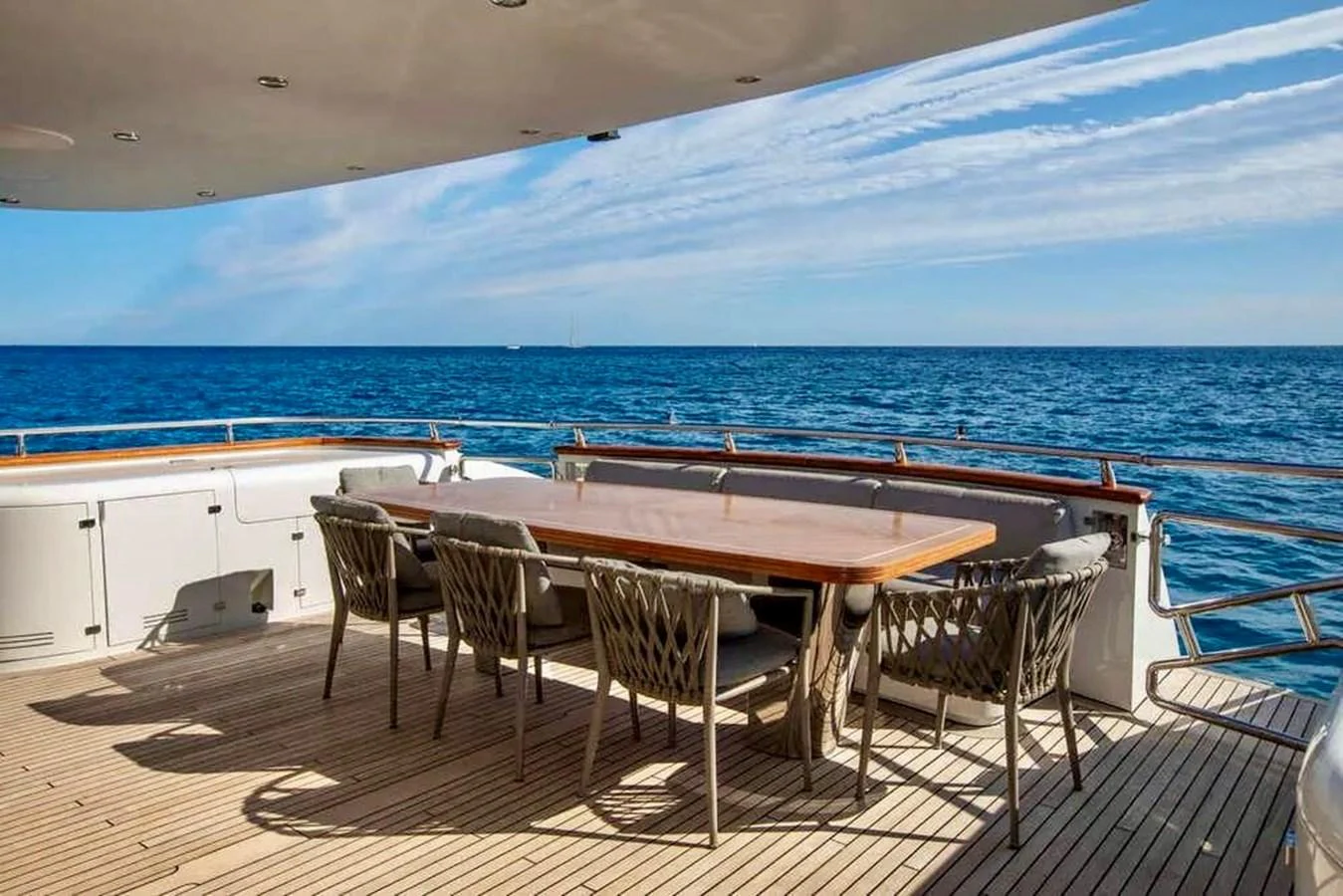 The aft deck features a spacious dining area with stunning ocean views. aboard BALANDRAU Yacht for Sale