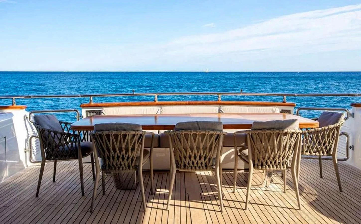 The aft deck features a spacious dining area with stunning ocean views. aboard BALANDRAU Yacht for Sale