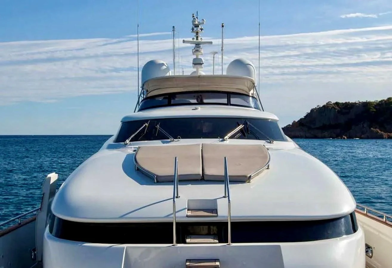 The yacht is seen from the front, showcasing its sleek design and luxurious features against a serene ocean backdrop. aboard BALANDRAU Yacht for Sale