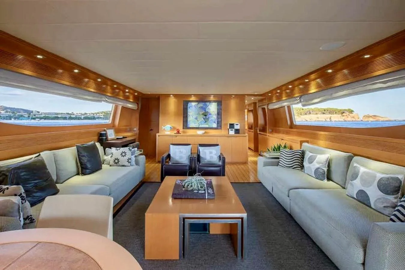 The yacht's salon features comfortable seating and large windows offering scenic views. aboard BALANDRAU Yacht for Sale