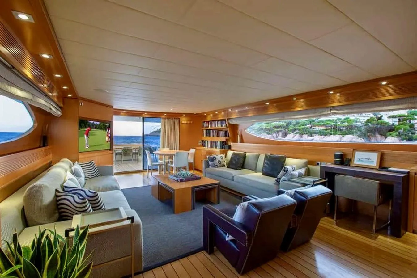 The salon features comfortable seating, a dining area, and large windows offering scenic views. aboard BALANDRAU Yacht for Sale