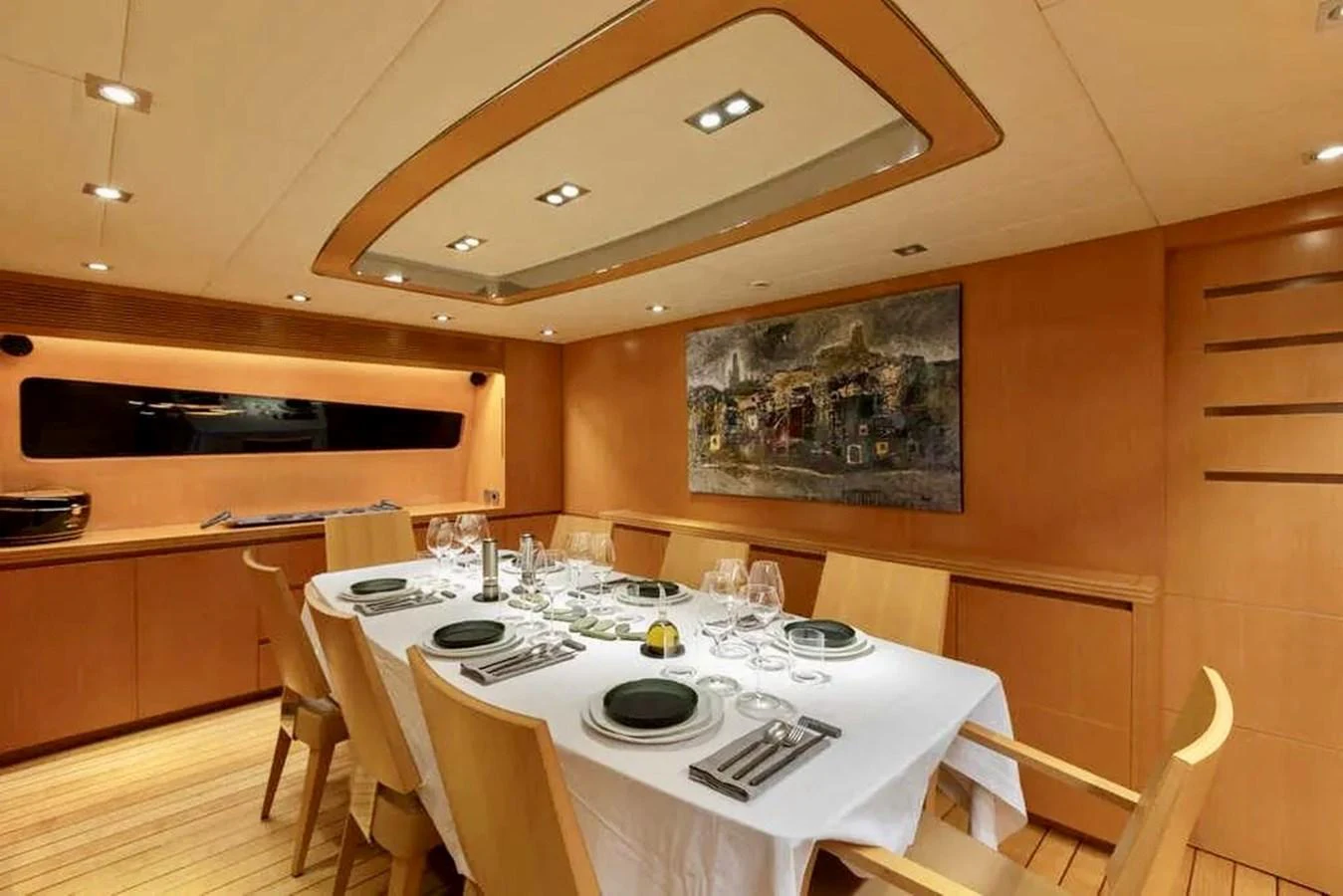 The yacht's dining area features elegant table settings and warm wooden decor. aboard BALANDRAU Yacht for Sale