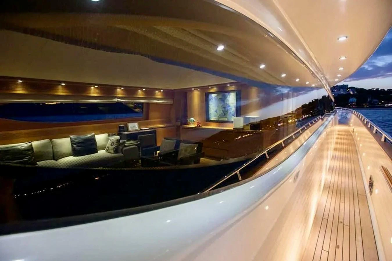 The yacht's deck offers a stunning view with elegant lighting and a glimpse into the luxurious interior. aboard BALANDRAU Yacht for Sale