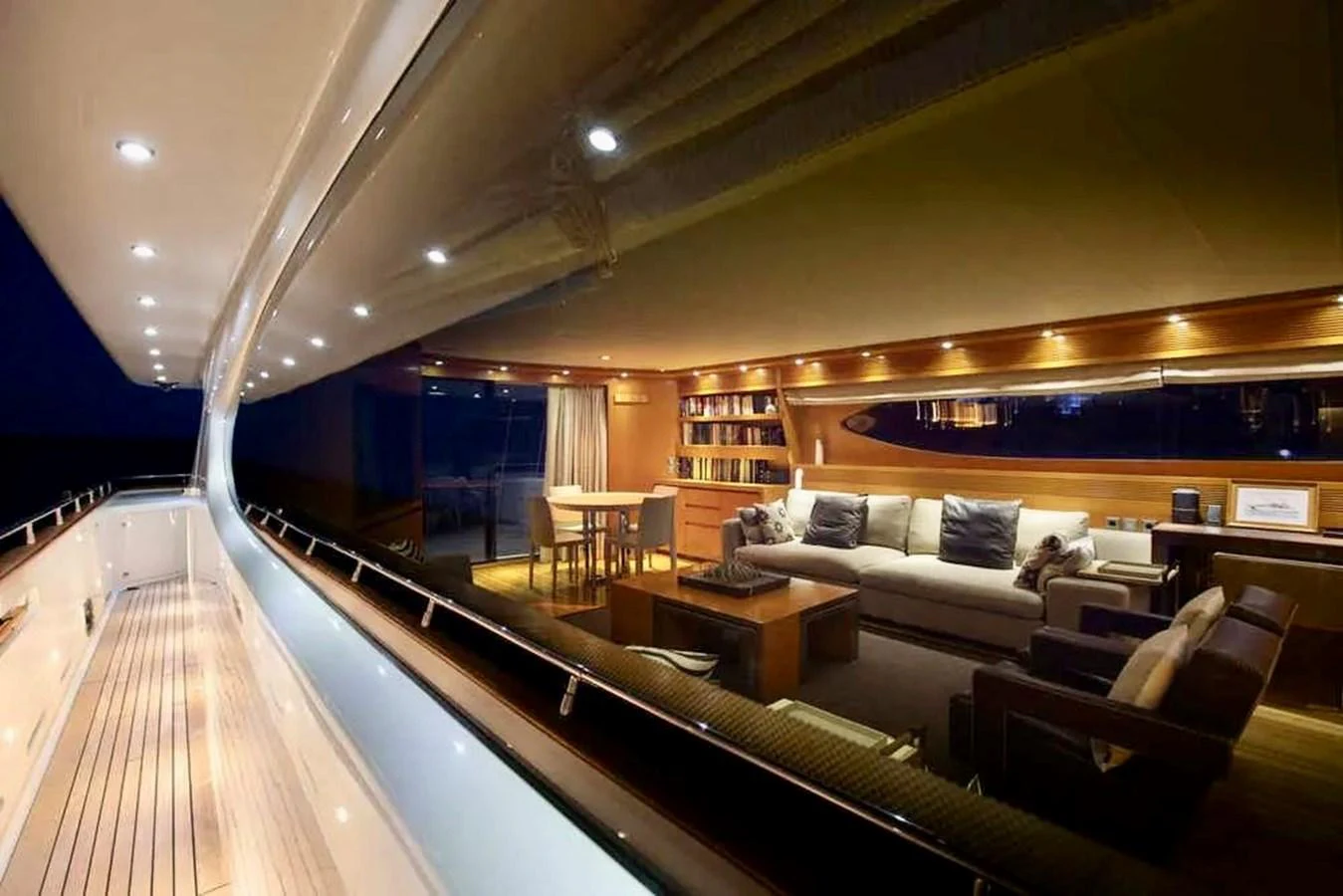 The yacht's salon features a cozy seating area with elegant lighting and modern furnishings. aboard BALANDRAU Yacht for Sale