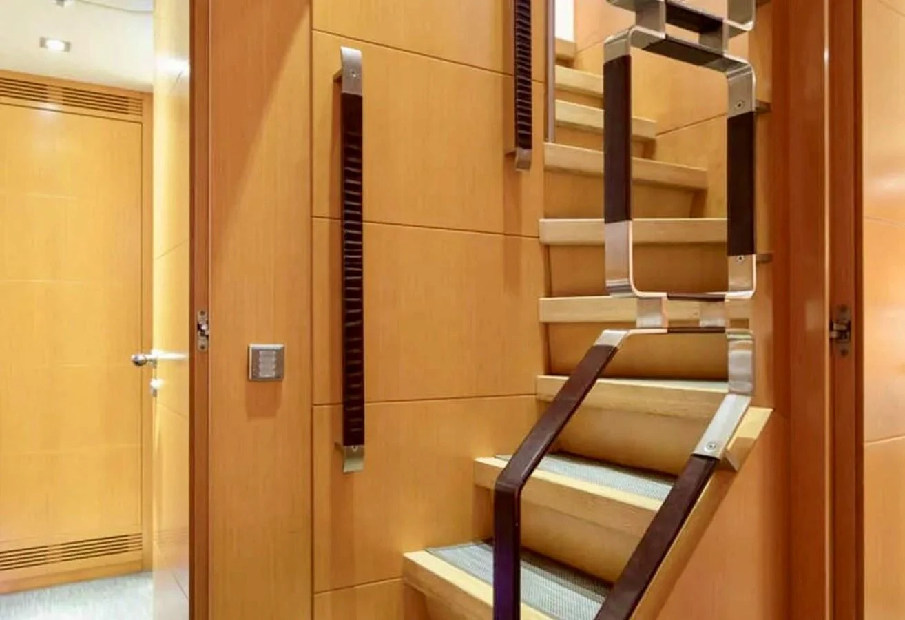 A stylish staircase with modern design elements inside the yacht. aboard BALANDRAU Yacht for Sale