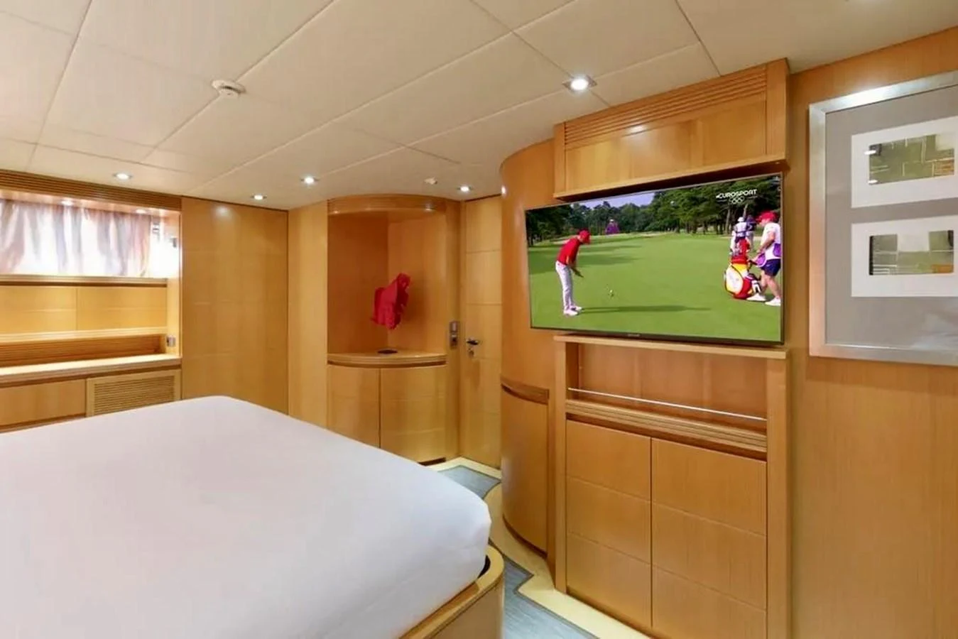 A cozy stateroom featuring a large bed and a flat-screen TV. aboard BALANDRAU Yacht for Sale