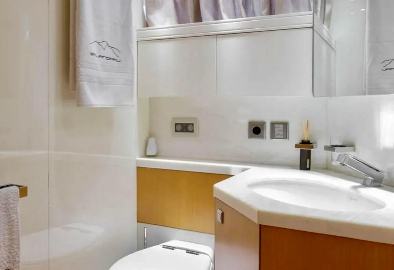 A modern yacht bathroom featuring sleek fixtures and clean design. aboard BALANDRAU Yacht for Sale