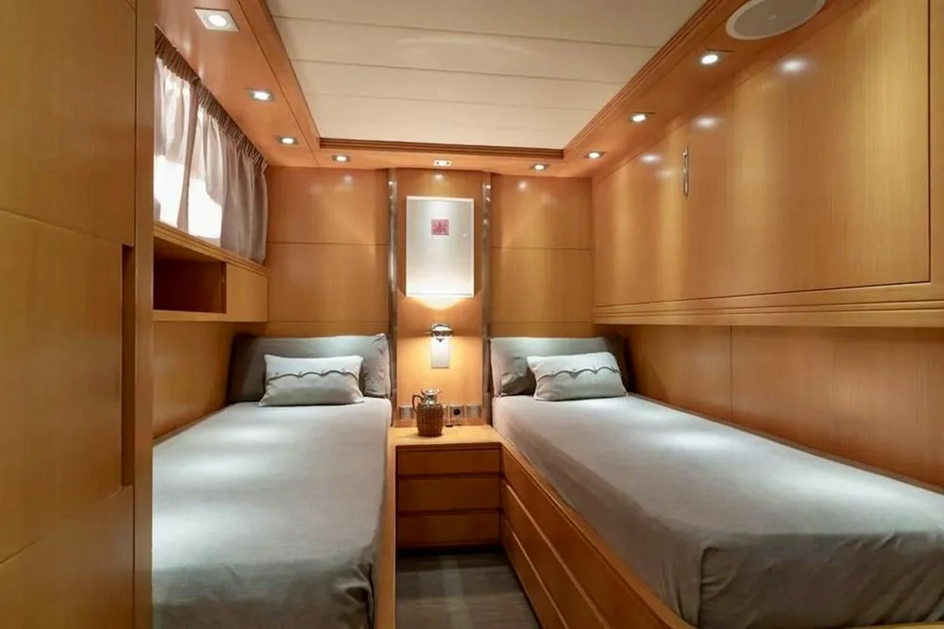 The guest stateroom features twin beds and elegant wood paneling. aboard BALANDRAU Yacht for Sale