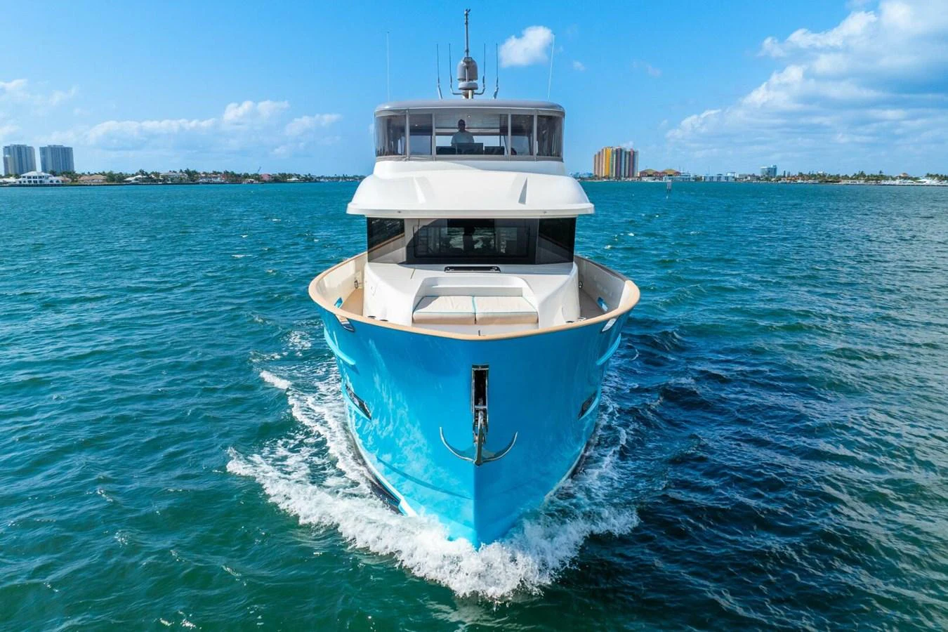 A sleek yacht cruises through the water under a clear blue sky. aboard LADY SADIE Yacht for Sale