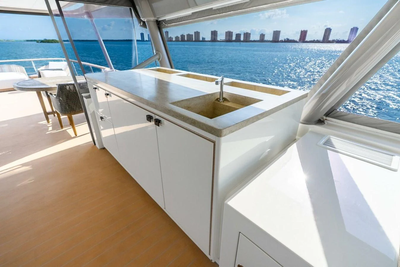 The flybridge features a sleek outdoor kitchen with stunning ocean views. aboard LADY SADIE Yacht for Sale