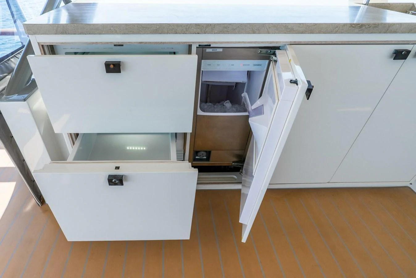 The image showcases the galley area with open drawers and a refrigerator, highlighting storage and functionality. aboard LADY SADIE Yacht for Sale