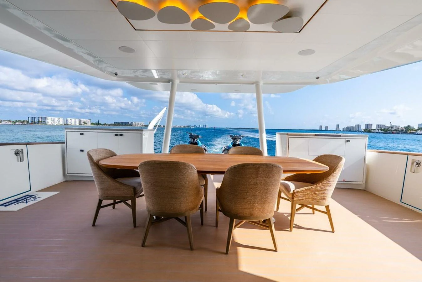 The aft deck features a stylish dining area with a stunning ocean view. aboard LADY SADIE Yacht for Sale