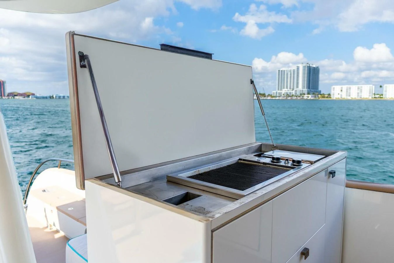 The yacht features a sleek outdoor kitchen with a grill and stove, perfect for alfresco dining. aboard LADY SADIE Yacht for Sale