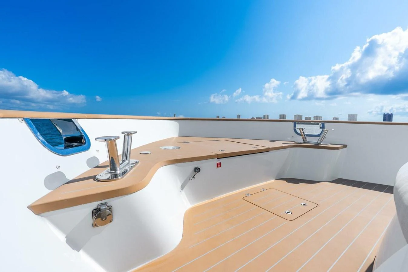 A clean and modern deck detail with polished fittings under a bright blue sky. aboard LADY SADIE Yacht for Sale