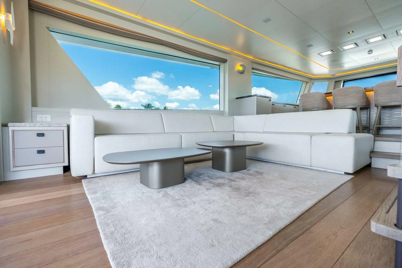The salon features a spacious seating area with modern furnishings and large windows providing ample natural light. aboard LADY SADIE Yacht for Sale